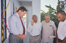 Rev. C. George praying during the building inauguaraion cermony